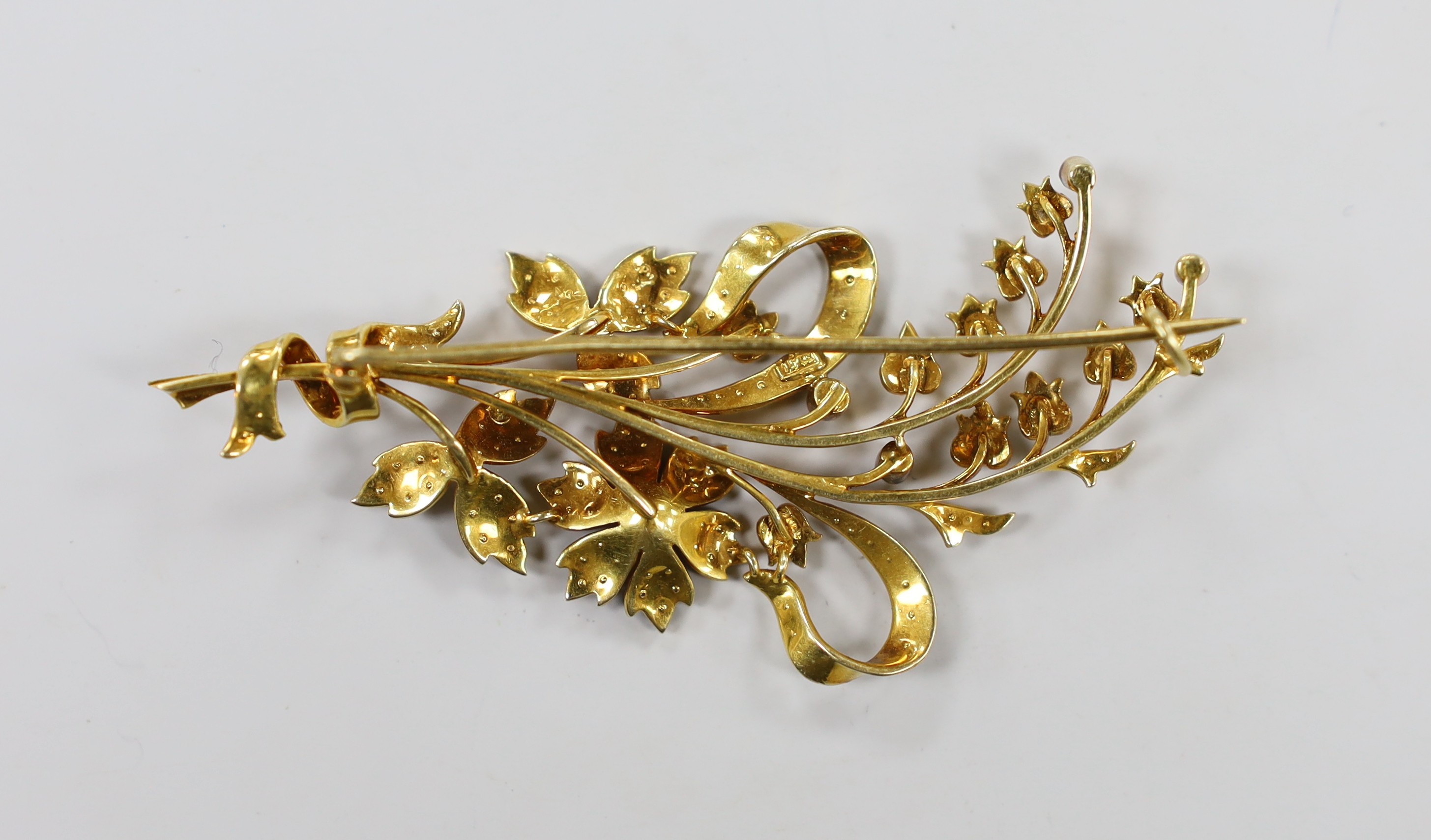 An Edwardian 15ct and seed pearl set floral spray brooch, 76mm, gross weight 13.5 grams.